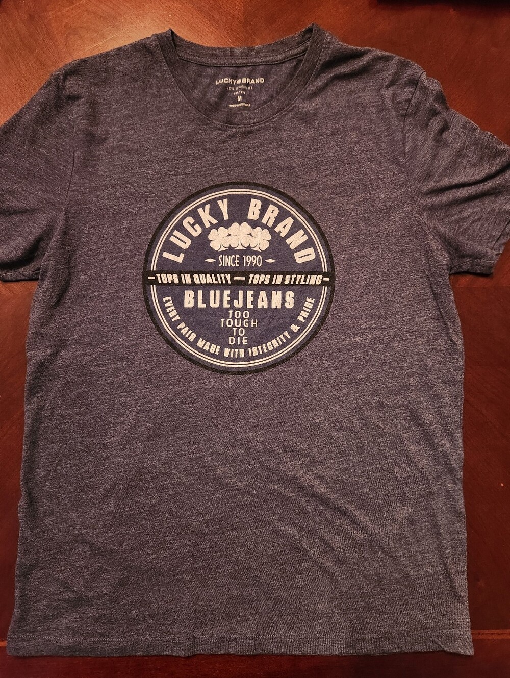 Lucky Brand Menโs Heather Navy Graphic Tee with Cream Logo